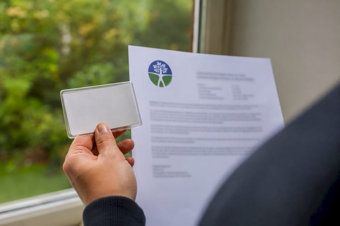 Hand holding licensing and insurance proof